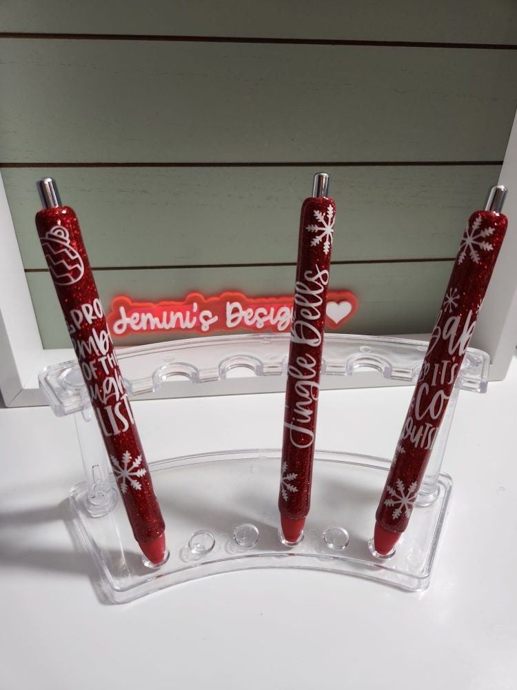 Set of 3 red glitter with white decals. Baby its cold outside/jingle bells/ proud member of the naughty list.  Glitter Gel pens/ refillable