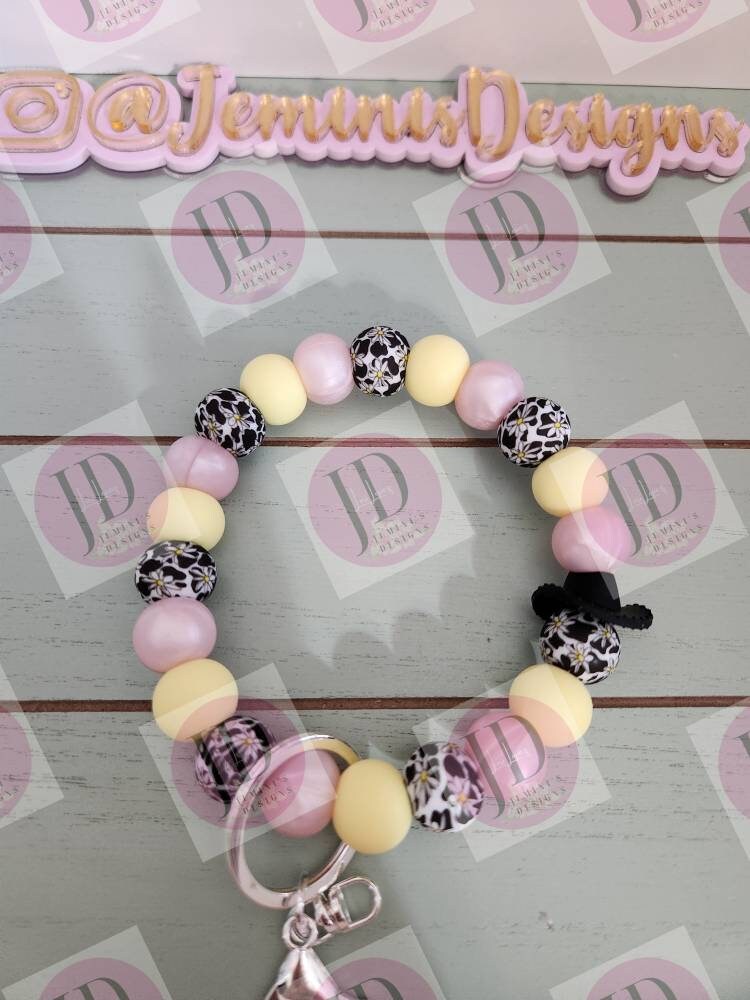 Cowboy pink pearl and soft yellow daisy cow Keychain.   Daisy bead w/ cow print. Cowboy hat bead Keychain wristlet for her