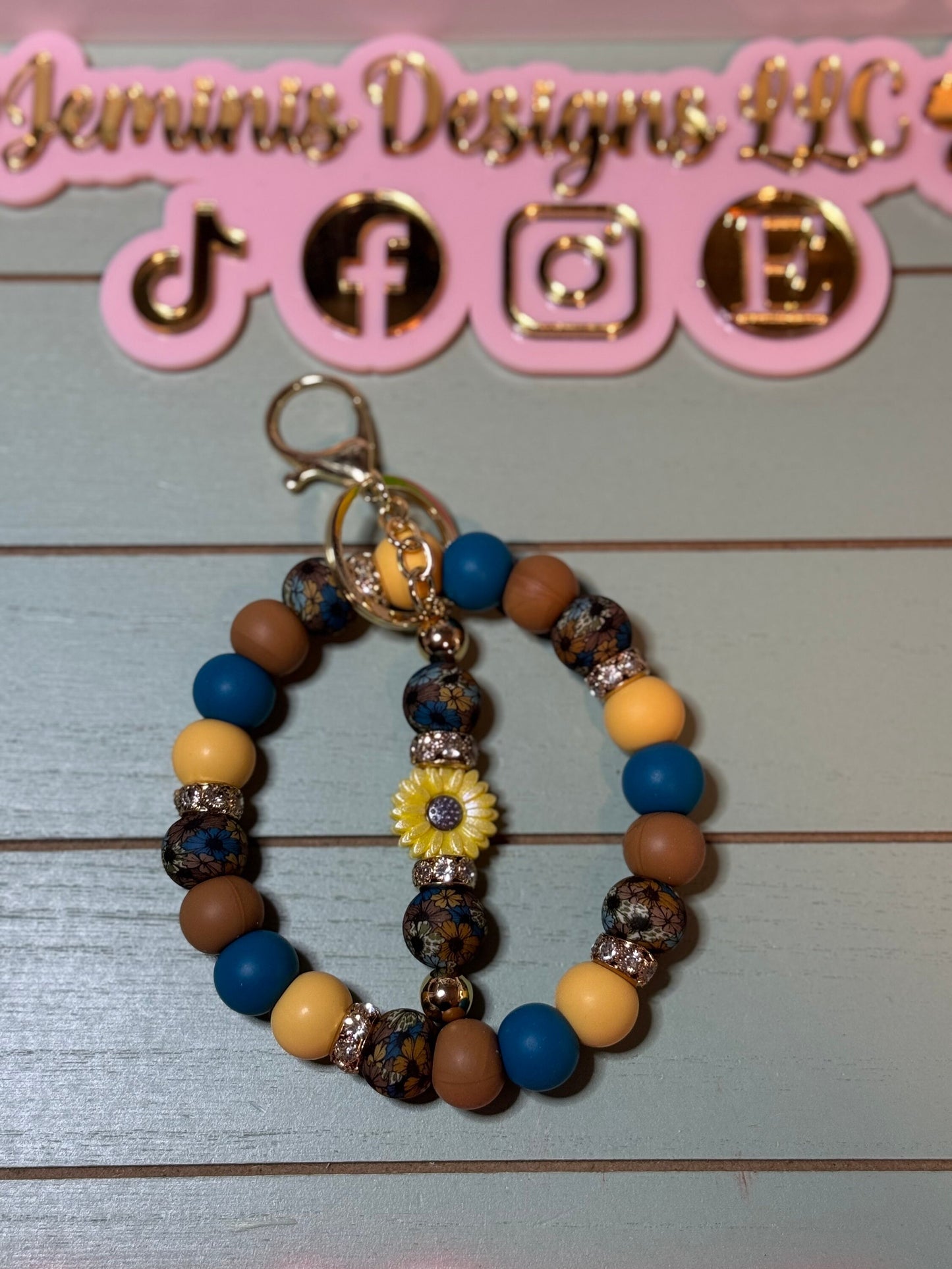 Floral brown and blue fall leaves beaded wristlets keychain, with daisy keychain bar, and bling.  Bangle wristlets floral fall colors