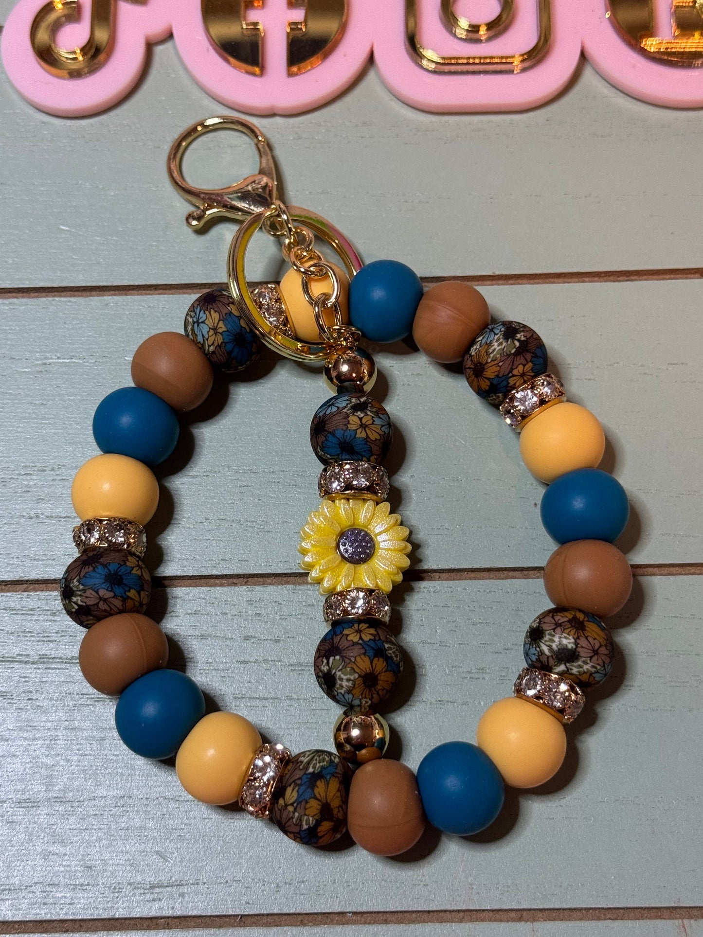 Floral brown and blue fall leaves beaded wristlets keychain, with daisy keychain bar, and bling.  Bangle wristlets floral fall colors