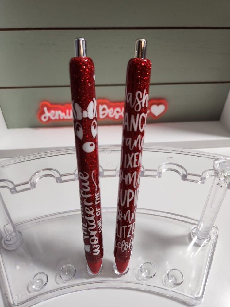 Set of 2 red glitter with white decals. Reindeer names/ clarice & Its the most wonderful time of the year Glitter Gel pens/ refillable