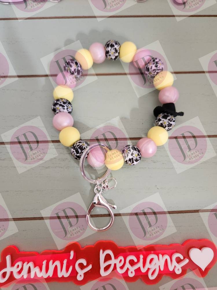 Cowboy pink pearl and soft yellow daisy cow Keychain.   Daisy bead w/ cow print. Cowboy hat bead Keychain wristlet for her